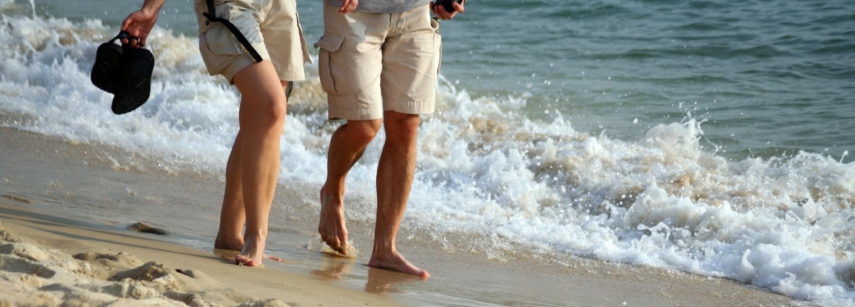 Man en vrouw wandelen op het strand